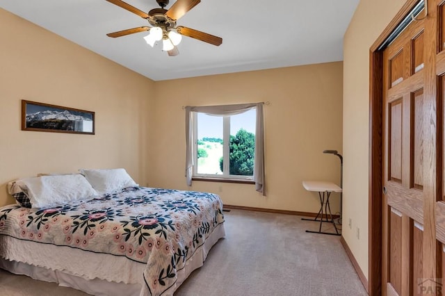 bedroom with baseboards, a ceiling fan, and light colored carpet