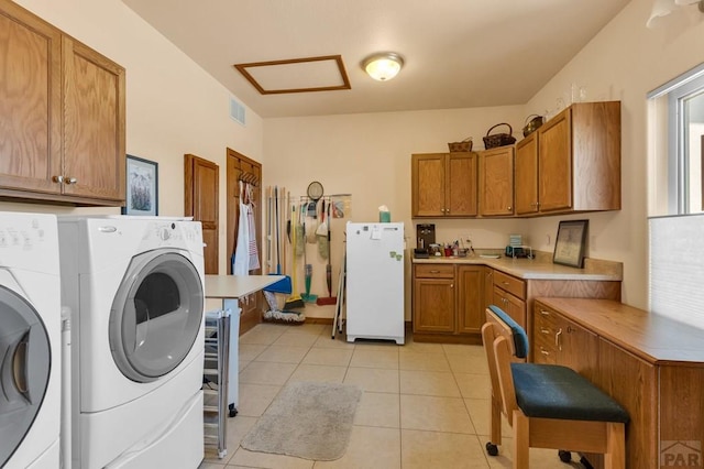 laundry room with cabinet space, light tile patterned floors, attic access, visible vents, and washing machine and dryer