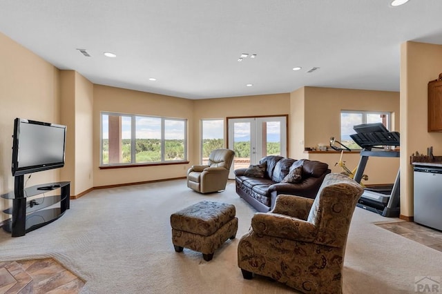 living room featuring visible vents, baseboards, light colored carpet, french doors, and recessed lighting