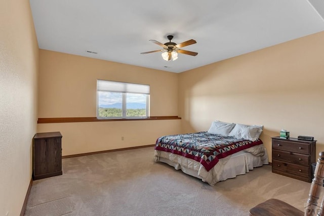 bedroom with light carpet, visible vents, a ceiling fan, and baseboards