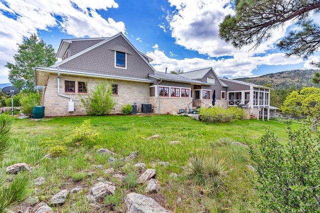 6430 Signal Mountain Rd, Beulah, CO 81023 - rear view of house with central AC, stone siding, a sunroom, and a yard