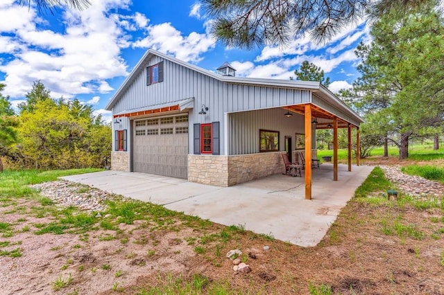 6430 Signal Mountain Rd, Beulah, CO 81023 - view of property exterior with stone siding, board and batten siding, ceiling fan, concrete driveway, and a patio area