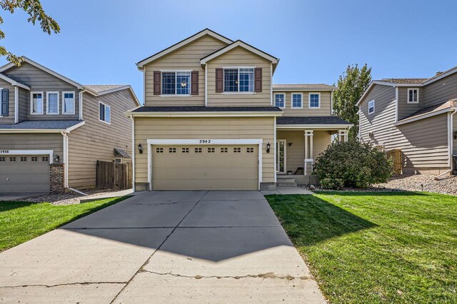 traditional-style house featuring concrete driveway, fence, a front lawn, and an attached garage