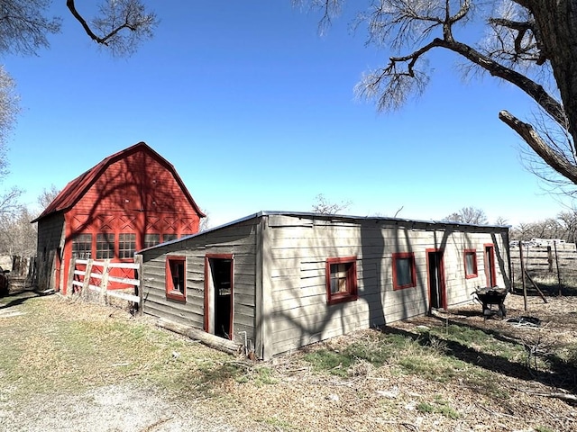 view of barn with fence