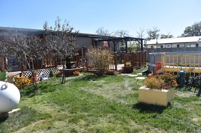 view of yard with a wooden deck and a pergola