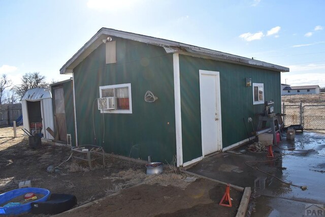 view of outbuilding with fence