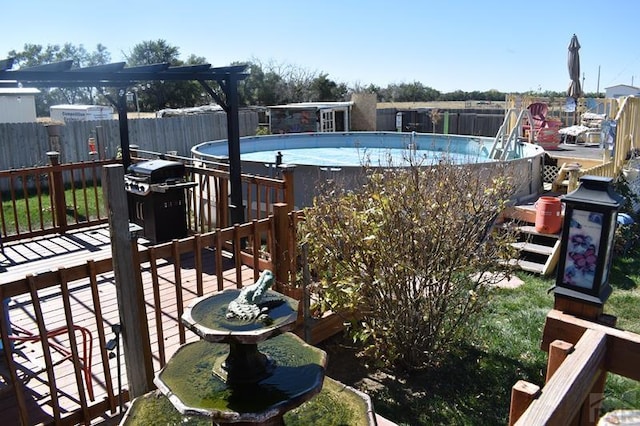 view of pool featuring a deck, fence, grilling area, and a fenced in pool