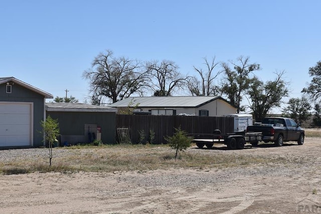 view of home's exterior with a garage and fence