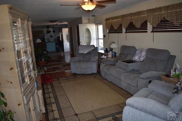 living room featuring light tile patterned floors and a ceiling fan