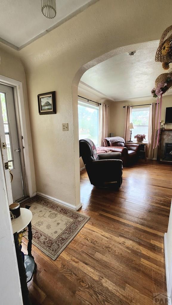 2631 Cedar St, Pueblo, CO 81004 - living area with arched walkways, wood finished floors, and baseboards