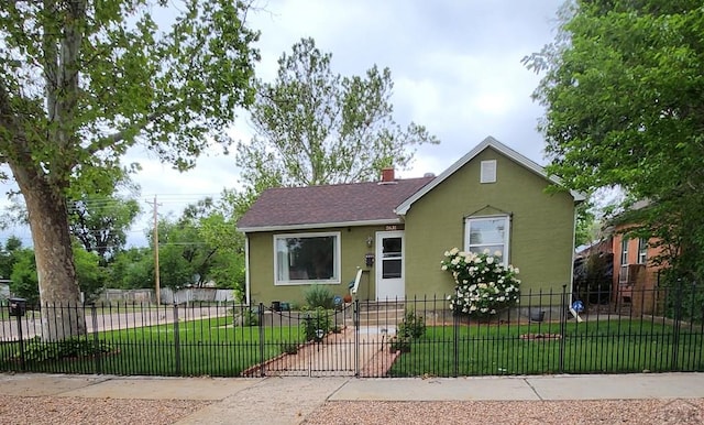 2631 Cedar St, Pueblo, CO 81004 - bungalow-style house with stucco siding, a chimney, and roof with shingles