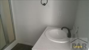 bathroom featuring a sink and a shower stall