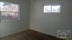 unfurnished room featuring baseboards