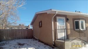 view of snow covered exterior featuring fence private yard