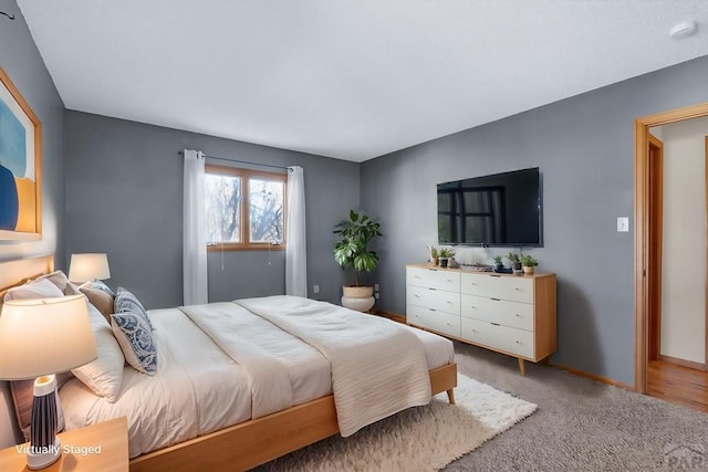 bedroom with carpet floors and baseboards