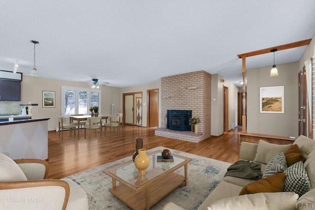 living room featuring light wood-style floors and ceiling fan