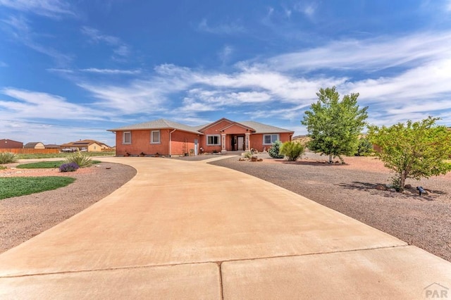 1284 N Challenger Dr, Pueblo West, CO 81007 - ranch-style house featuring curved driveway