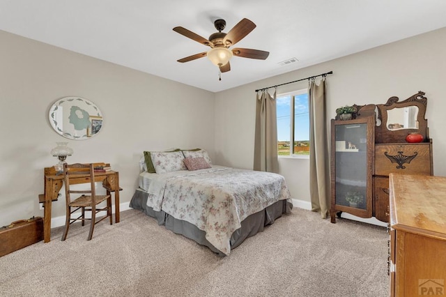 1284 N Challenger Dr, Pueblo West, CO 81007 - bedroom with light colored carpet, baseboards, and ceiling fan