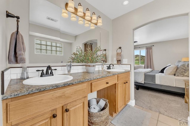 1284 N Challenger Dr, Pueblo West, CO 81007 - ensuite bathroom featuring double vanity and tile patterned floors