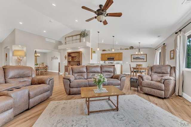 1284 N Challenger Dr, Pueblo West, CO 81007 - living area with a chandelier, vaulted ceiling, baseboards, a ceiling fan, and arched walkways