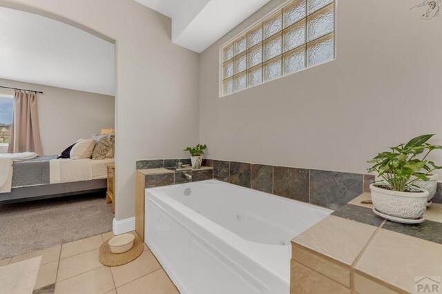 1284 N Challenger Dr, Pueblo West, CO 81007 - full bathroom featuring a garden tub, plenty of natural light, ensuite bathroom, and tile patterned flooring
