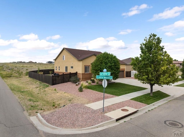 4288 Cedarweed Blvd, Pueblo, CO 81001 - view of front of property featuring stucco siding, concrete driveway, and a garage