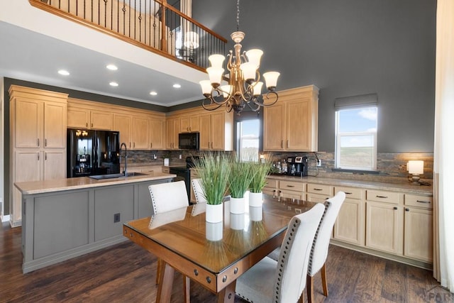 4288 Cedarweed Blvd, Pueblo, CO 81001 - kitchen with black appliances, light brown cabinets, a high ceiling, dark wood-style flooring, and a chandelier