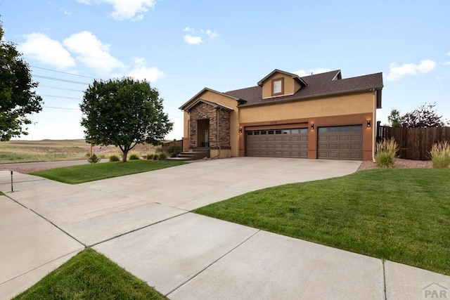 4288 Cedarweed Blvd, Pueblo, CO 81001 - view of front of house featuring a garage, stucco siding, and driveway
