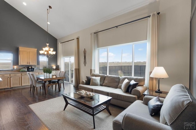 4288 Cedarweed Blvd, Pueblo, CO 81001 - living area with high vaulted ceiling, a chandelier, dark wood-type flooring, and plenty of natural light