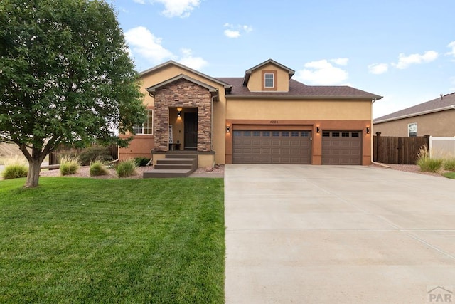4288 Cedarweed Blvd, Pueblo, CO 81001 - view of front of house featuring stucco siding, an attached garage, driveway, and stone siding