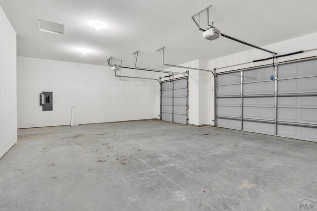 garage featuring a garage door opener and electric panel