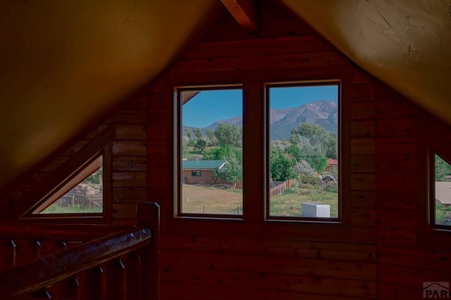 additional living space featuring a mountain view and vaulted ceiling