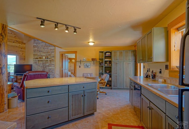 kitchen with light countertops, gray cabinetry, open floor plan, vaulted ceiling, and dishwashing machine