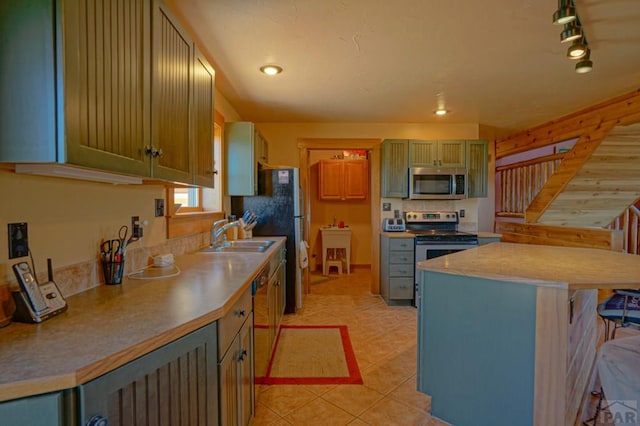 kitchen with light tile patterned floors, wine cooler, a sink, a kitchen breakfast bar, and appliances with stainless steel finishes