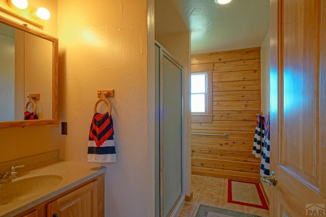 full bath featuring a shower stall, tile patterned flooring, and vanity