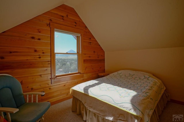 bedroom featuring light carpet, lofted ceiling, and wooden walls