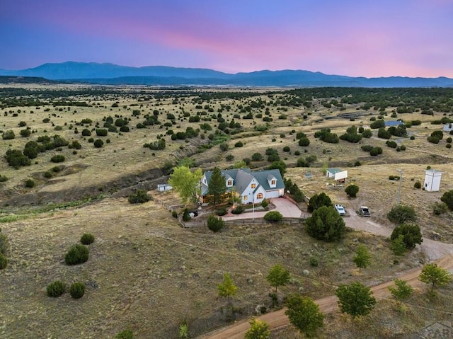 aerial view at dusk featuring a mountain view