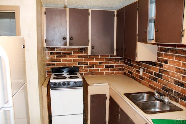 2006 W 13th St, Pueblo, CO 81001 - kitchen featuring white appliances, tasteful backsplash, and light countertops