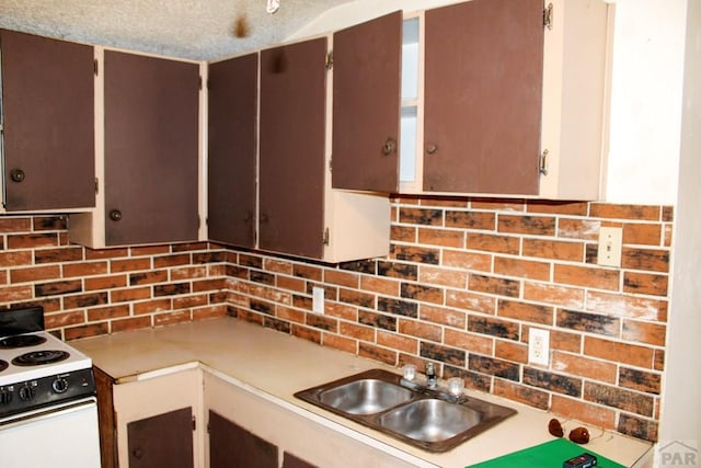 2006 W 13th St, Pueblo, CO 81001 - kitchen featuring electric stove, tasteful backsplash, and light countertops