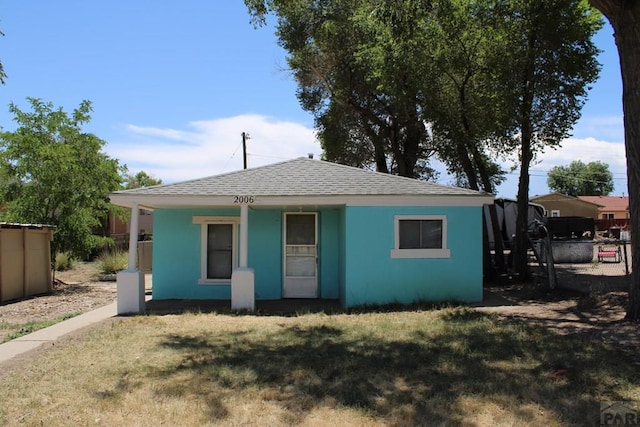 2006 W 13th St, Pueblo, CO 81001 - view of front of house featuring a shingled roof, a porch, and stucco siding
