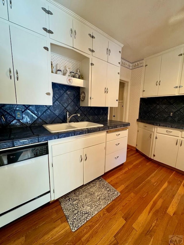kitchen featuring a sink, white cabinetry, dishwasher, and dark wood-style floors
