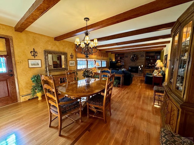 dining area featuring light wood finished floors, a notable chandelier, and a wealth of natural light