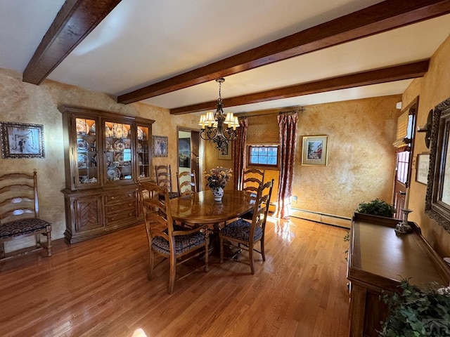 dining room featuring a baseboard heating unit, a chandelier, a textured wall, beamed ceiling, and light wood finished floors