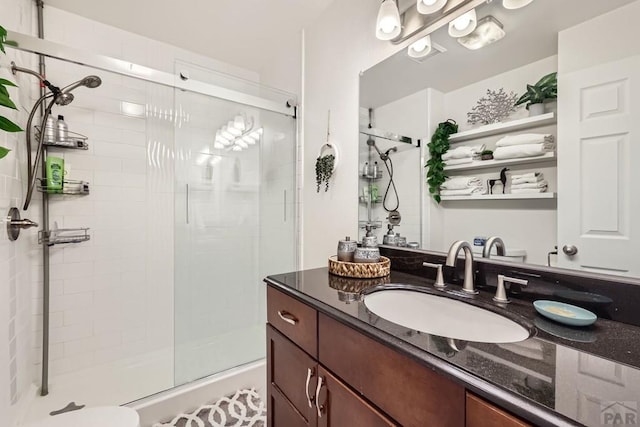 full bath with a shower stall and vanity