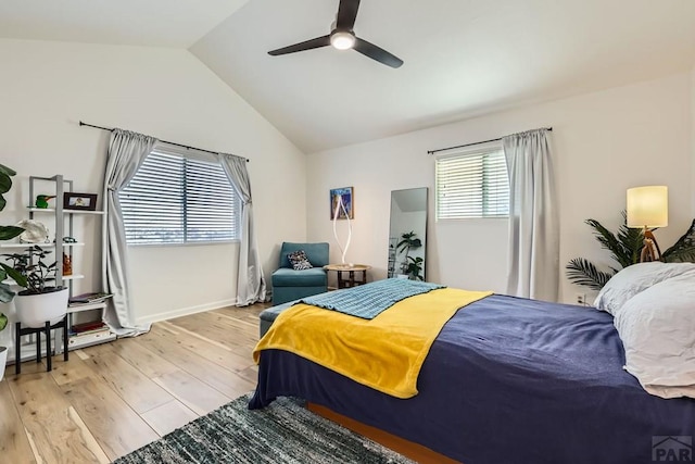 bedroom featuring lofted ceiling, ceiling fan, light wood-style flooring, and baseboards