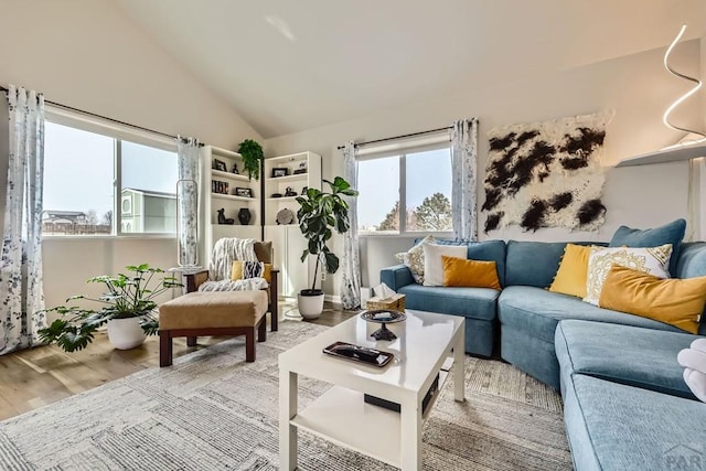 living room with lofted ceiling and wood finished floors