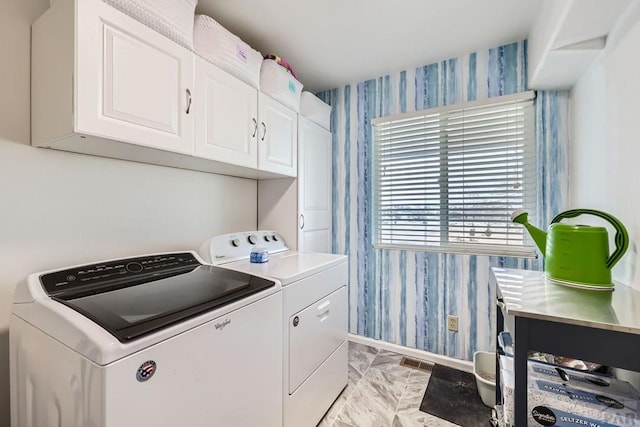 laundry area with visible vents, washing machine and dryer, cabinet space, and wallpapered walls