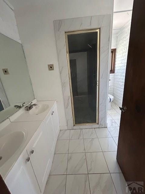 21 Terrace Dr, Pueblo, CO 81001 - bathroom featuring double vanity, toilet, a shower stall, and marble finish flooring