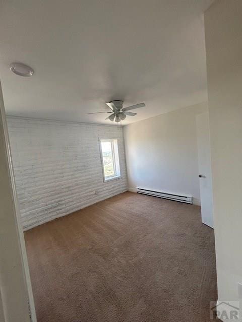21 Terrace Dr, Pueblo, CO 81001 - carpeted spare room featuring baseboard heating, brick wall, and ceiling fan