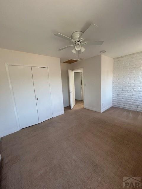 21 Terrace Dr, Pueblo, CO 81001 - unfurnished bedroom featuring carpet, baseboards, ceiling fan, a closet, and brick wall
